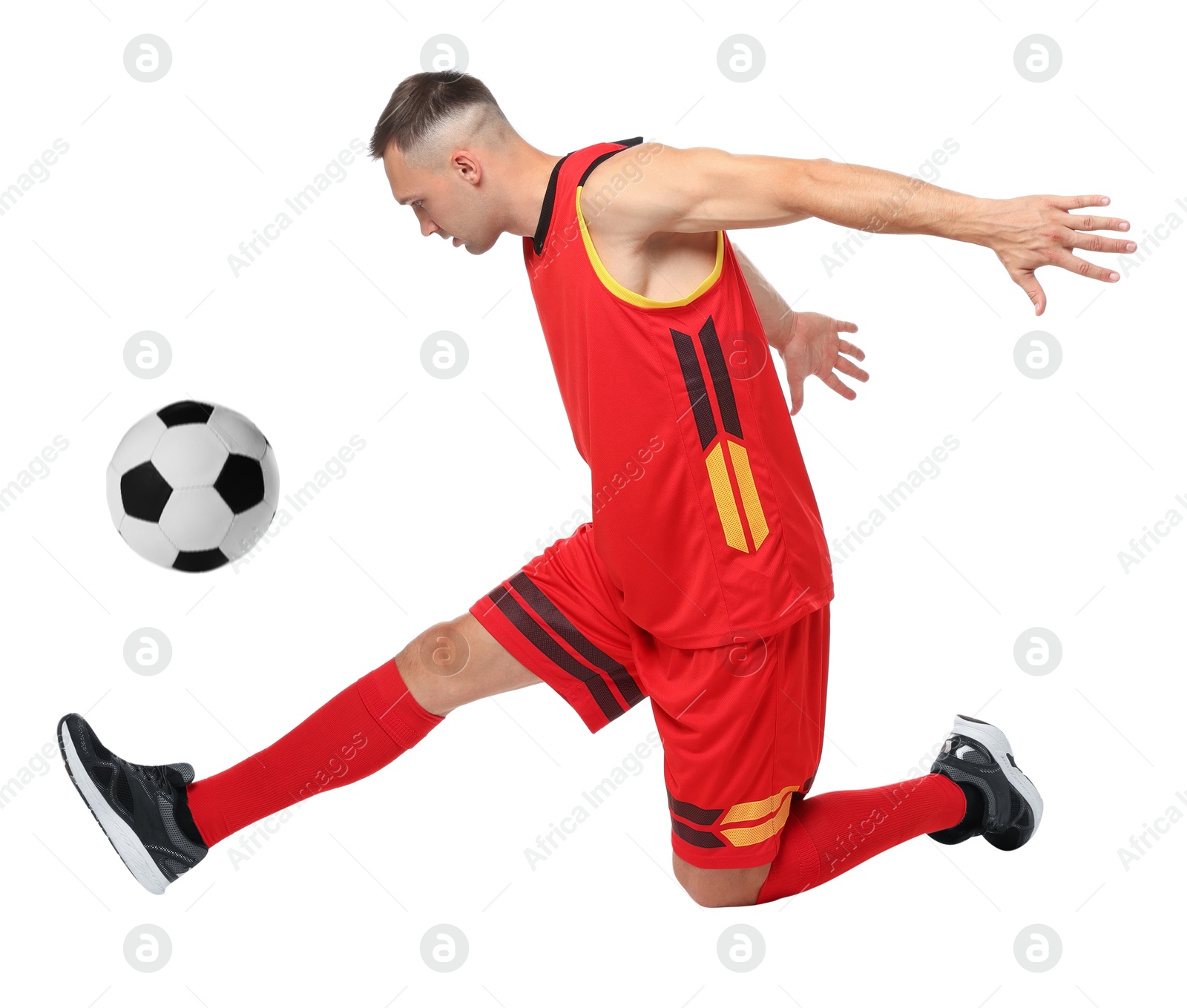 Image of Football player in sportswear kicking soccer ball on white background