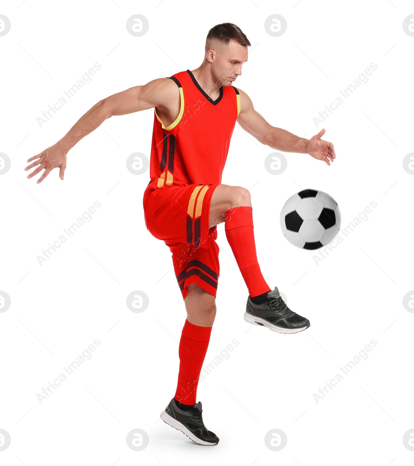 Image of Football player in sportswear kicking soccer ball on white background