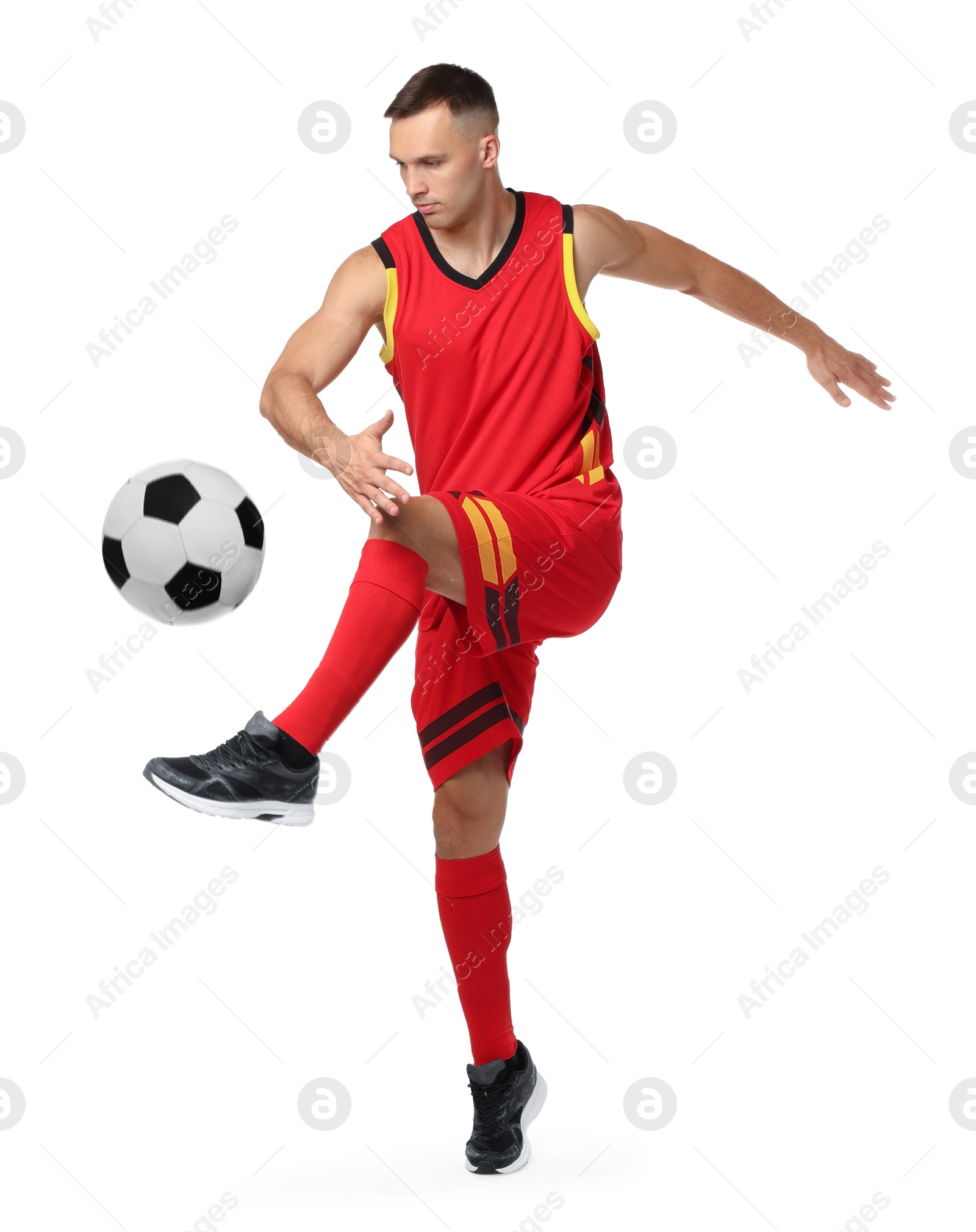 Image of Football player in sportswear kicking soccer ball on white background