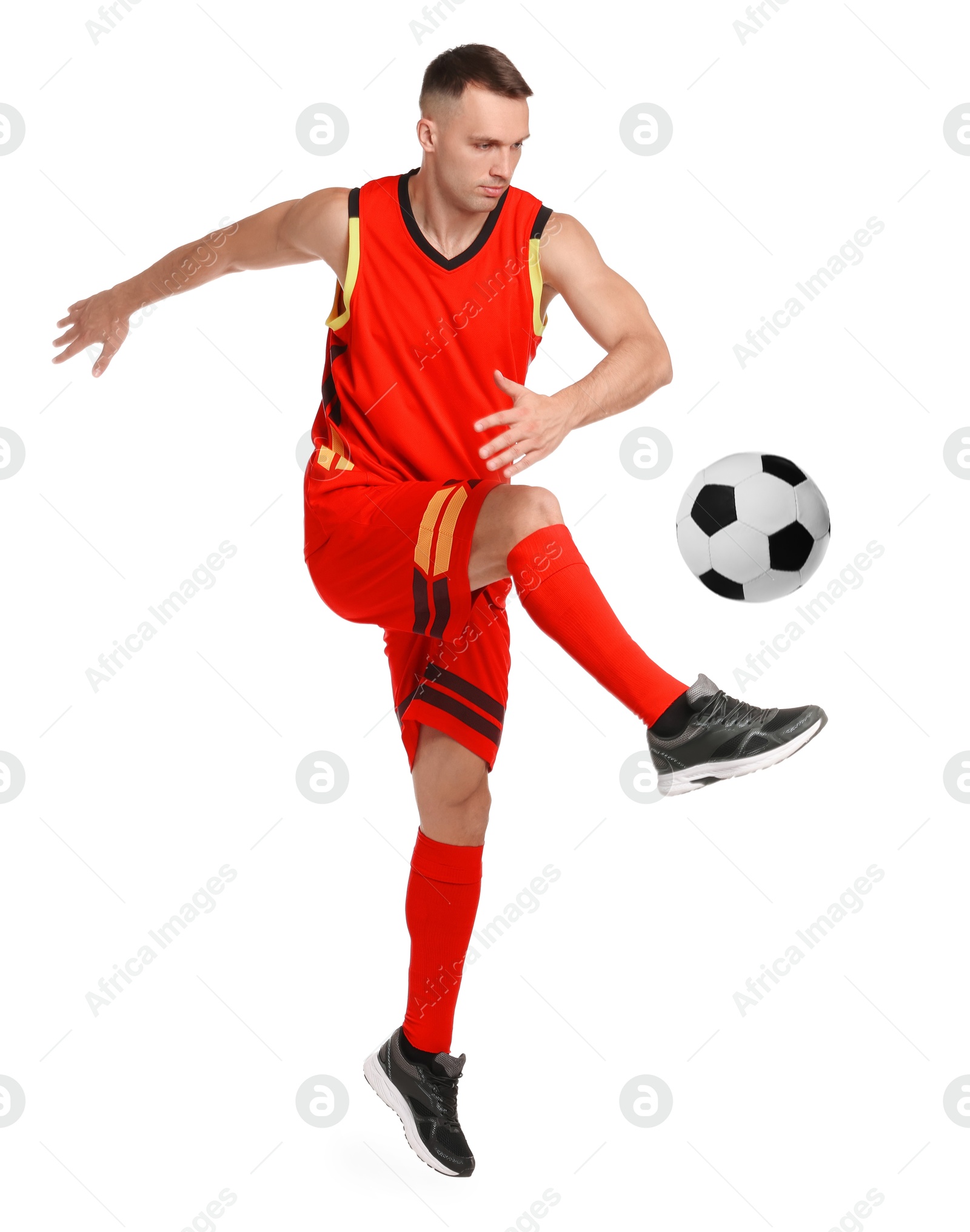 Image of Football player in sportswear kicking soccer ball on white background