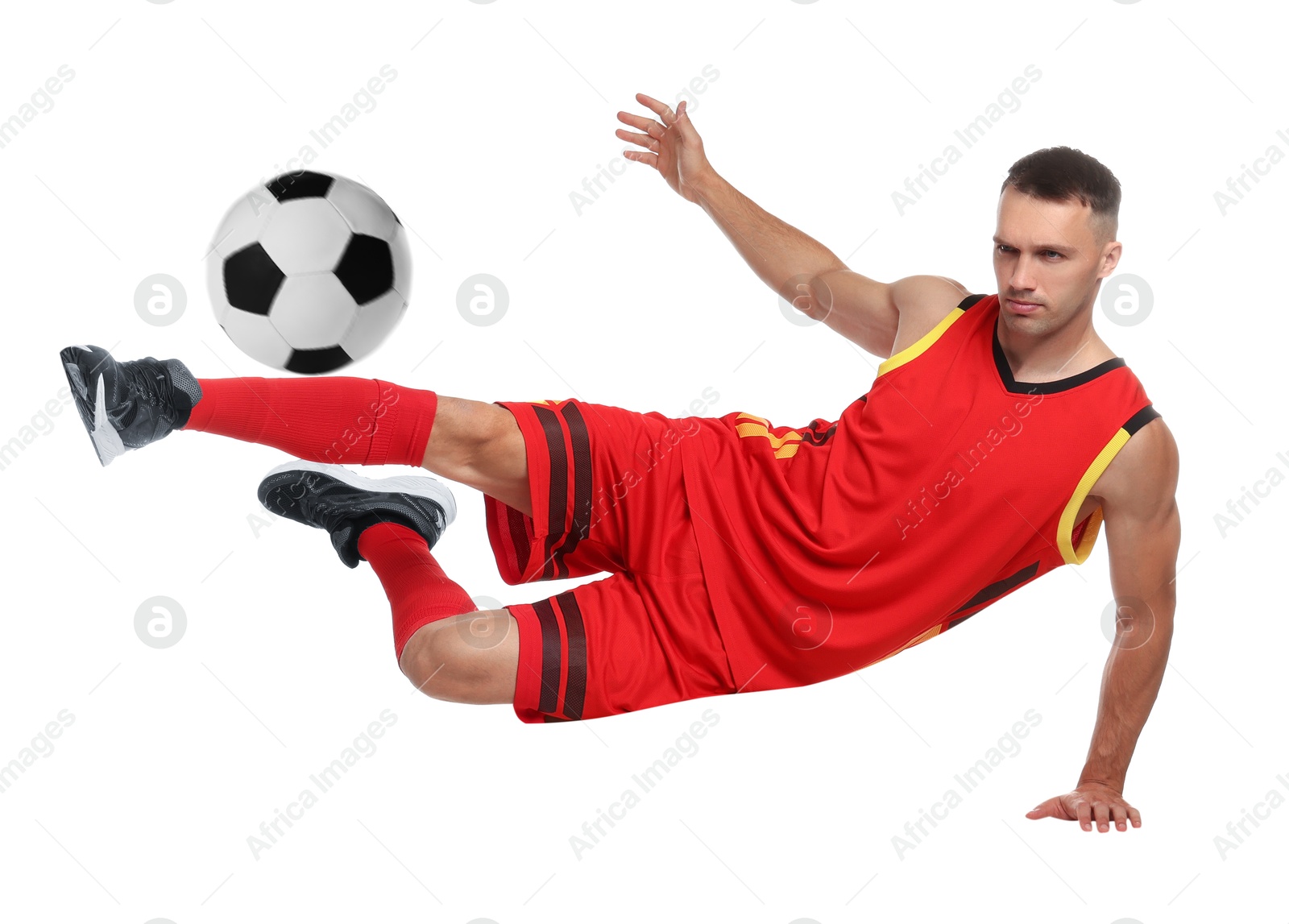 Image of Football player in sportswear kicking soccer ball on white background