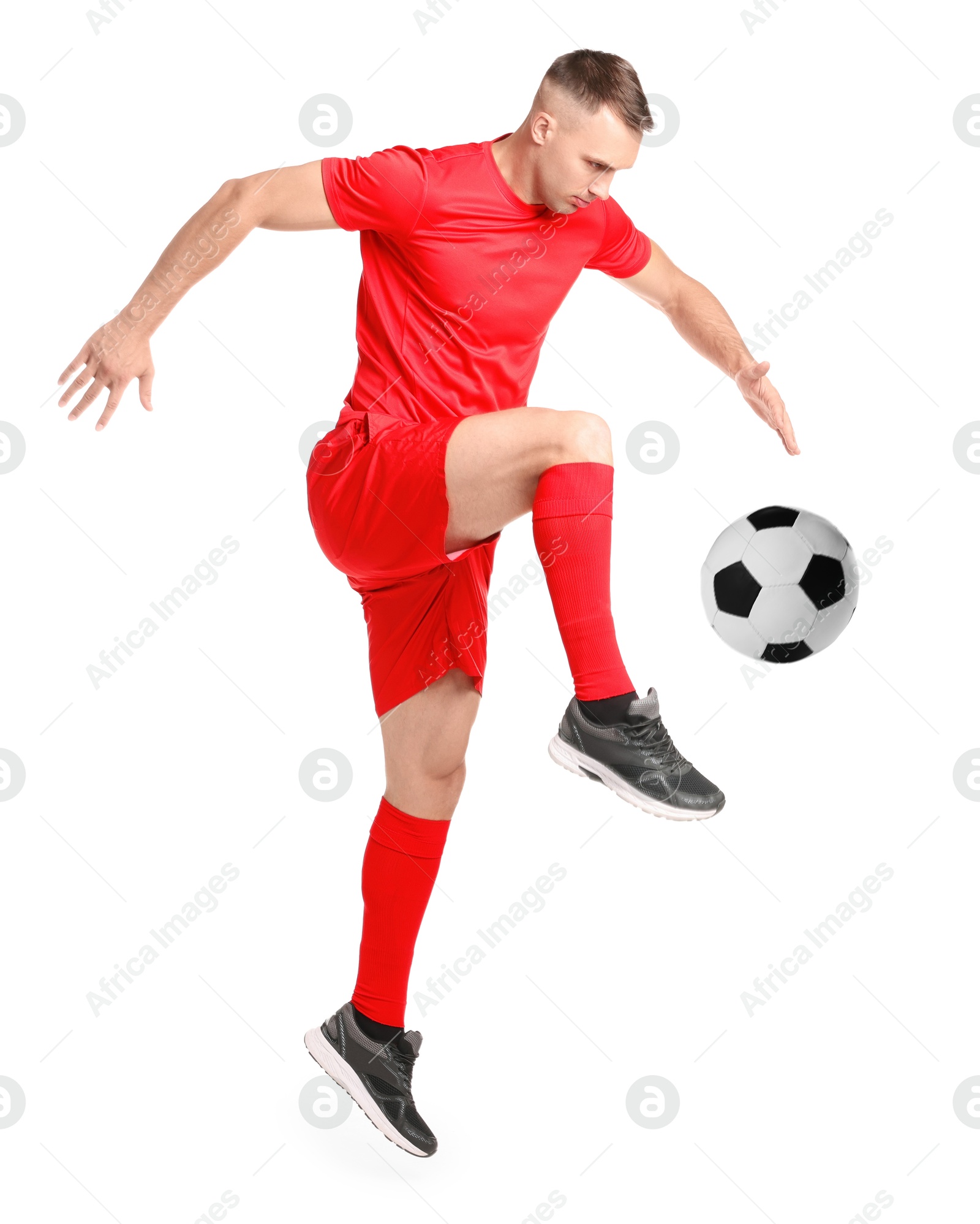 Image of Football player in sportswear kicking soccer ball on white background