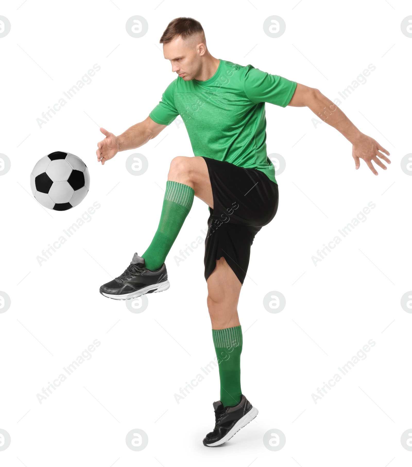 Image of Football player in sportswear kicking soccer ball on white background