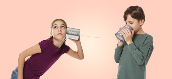 Image of Girl and boy using tin can telephone on pink beige background. Banner design