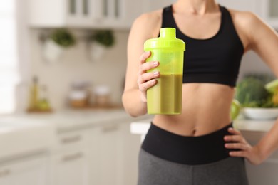 Photo of Weight loss. Woman with shaker of protein in kitchen, closeup. Space for text