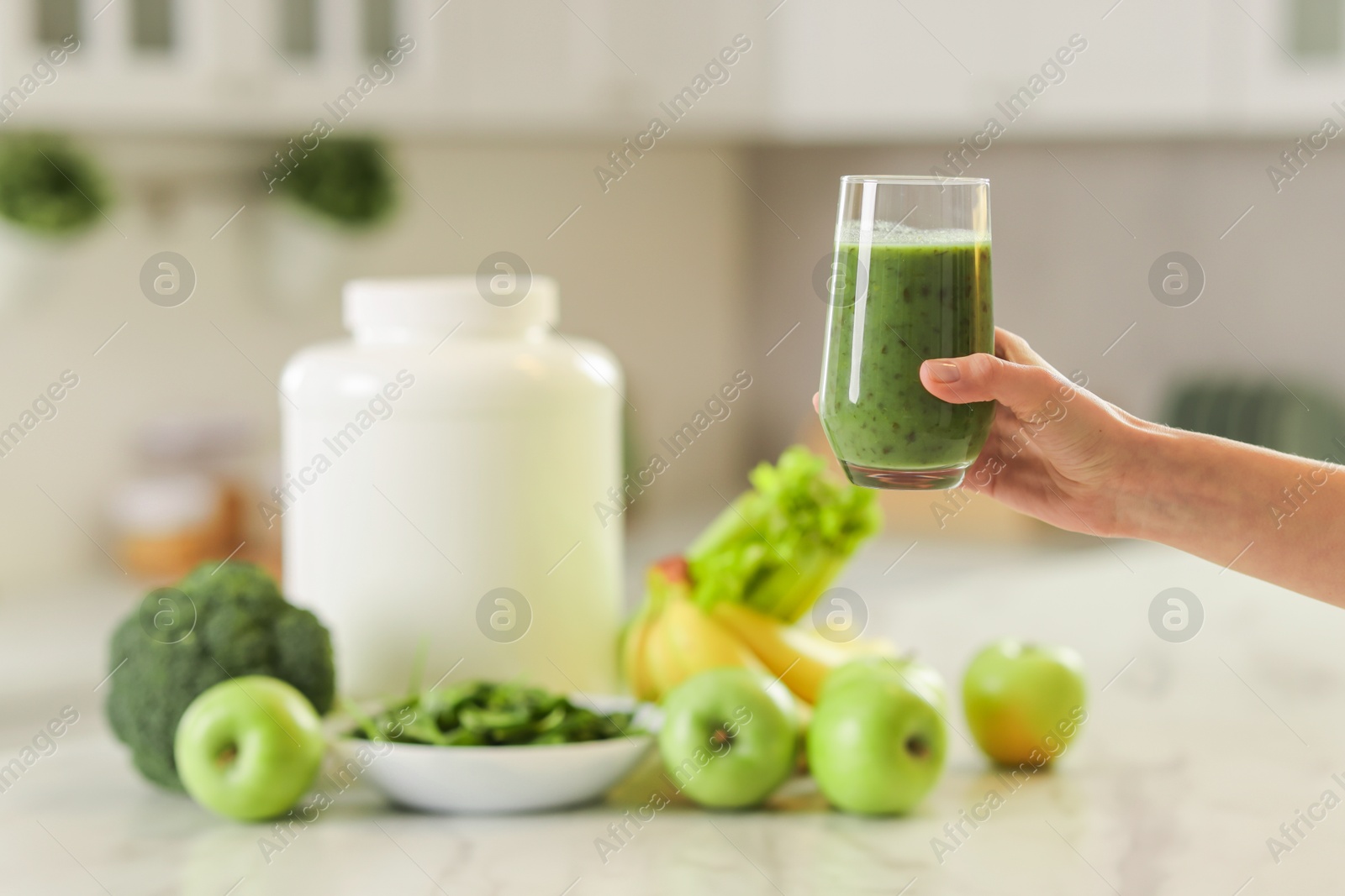 Photo of Weight loss. Woman with glass of healthy shake in kitchen, closeup. Space for text