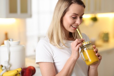 Photo of Weight loss. Woman with tasty shake in kitchen