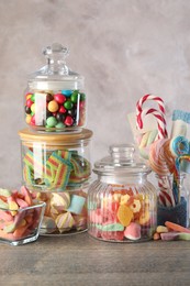 Candy bar. Many different sweets on wooden table against grey background