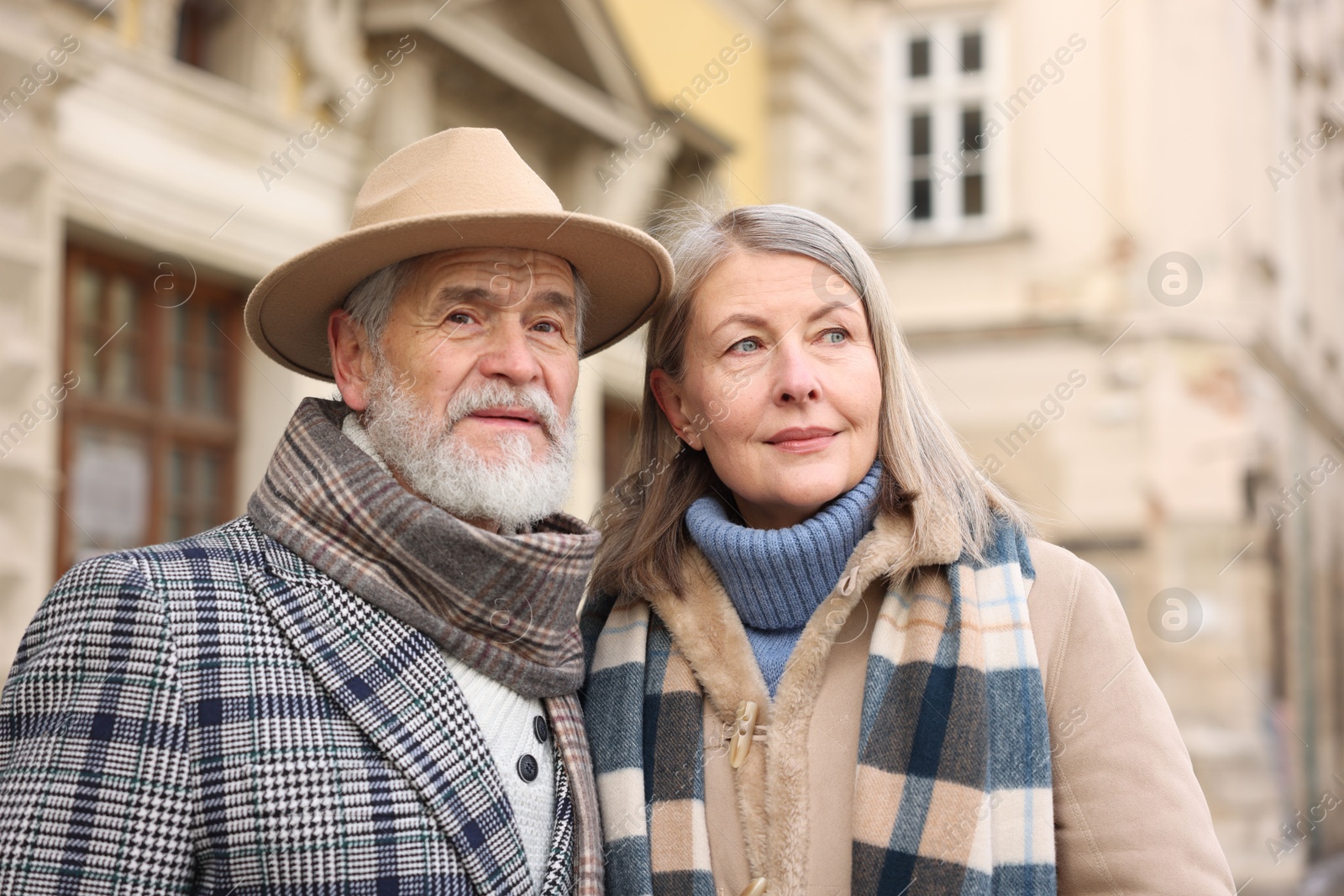 Photo of Lovely elderly couple together on city street