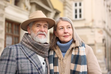 Photo of Lovely elderly couple together on city street