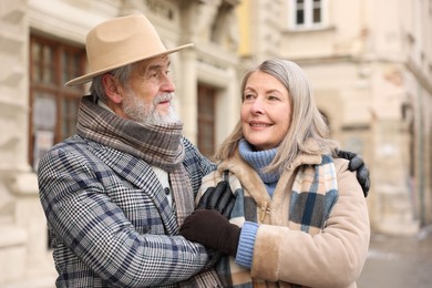 Photo of Lovely elderly couple together on city street