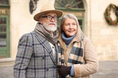 Photo of Lovely elderly couple together on city street