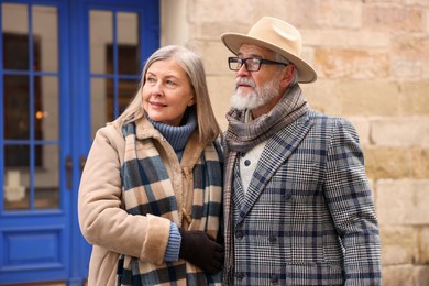 Photo of Lovely elderly couple together on city street