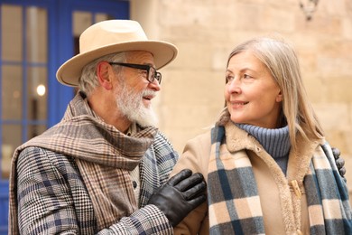 Photo of Happy elderly couple together on city street