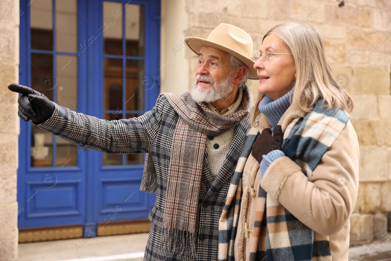 Photo of Happy elderly couple walking on city street