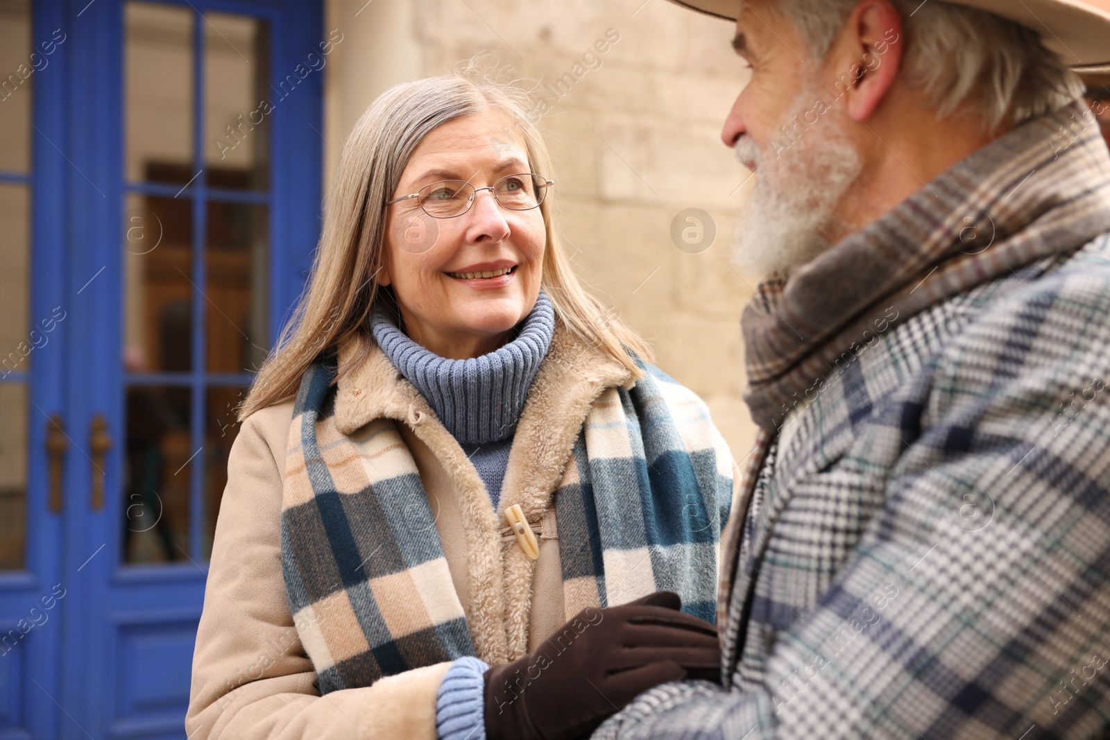 Photo of Lovely elderly couple holding hands on city street