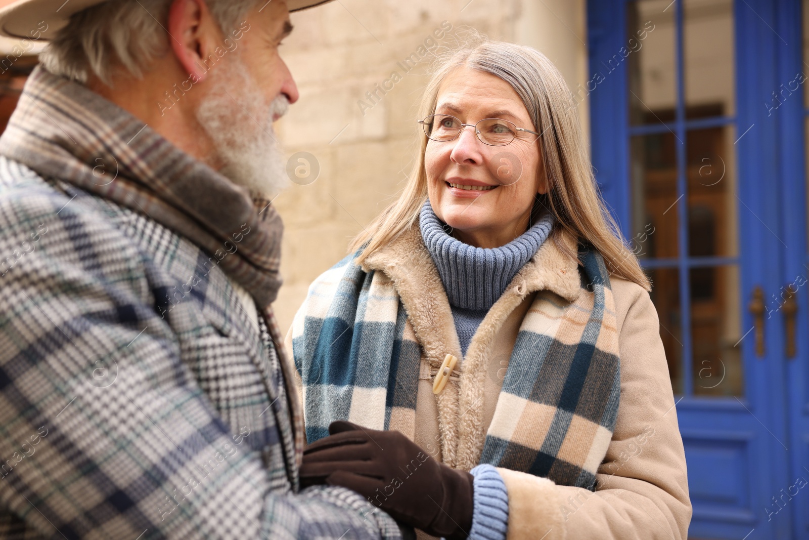 Photo of Lovely elderly couple holding hands on city street