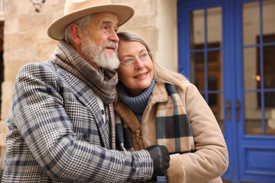 Photo of Lovely elderly couple holding hands on city street