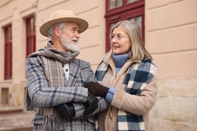 Photo of Lovely elderly couple together on city street