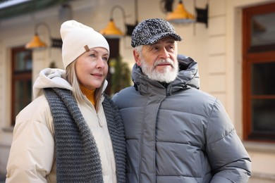 Photo of Happy elderly couple walking on city street