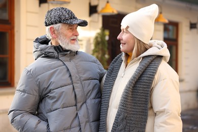 Photo of Happy elderly couple walking on city street