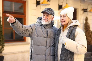 Photo of Happy elderly couple walking on city street