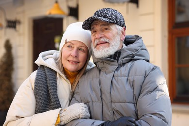 Lovely elderly couple together on city street