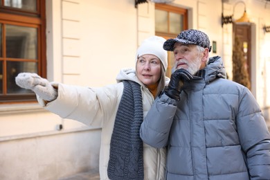 Photo of Lovely elderly couple walking on city street