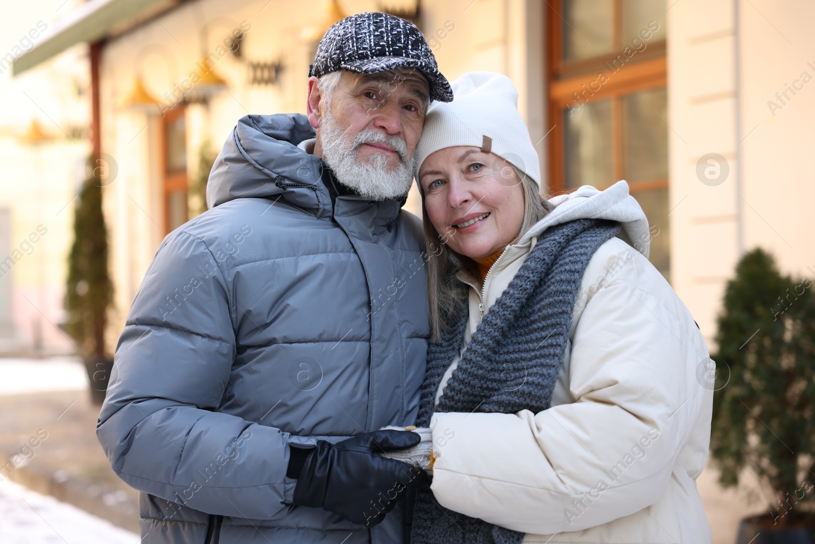 Photo of Lovely elderly couple holding hands on city street