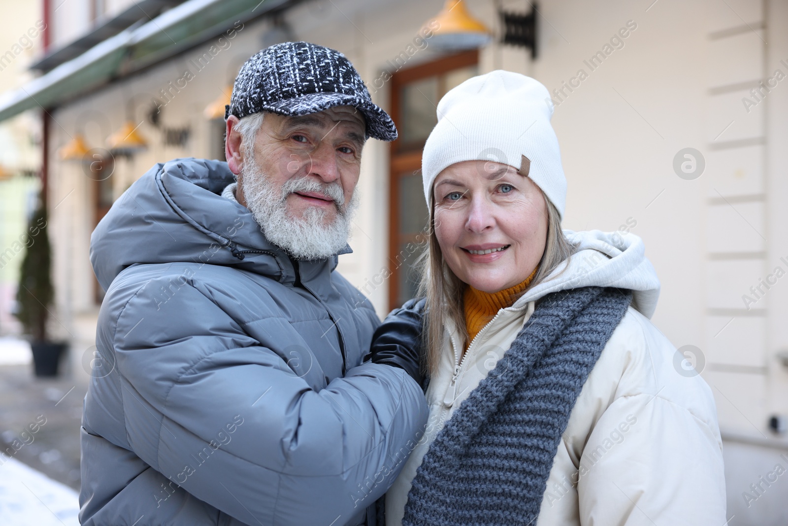 Photo of Family portrait of happy elderly couple on city street