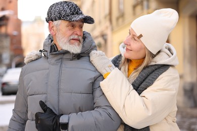 Photo of Lovely elderly couple together on city street