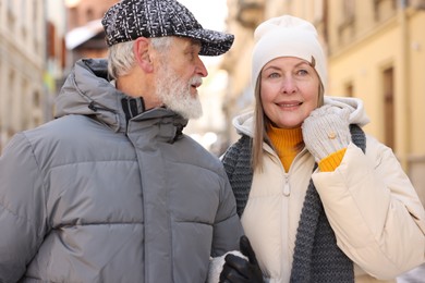 Lovely elderly couple together on city street