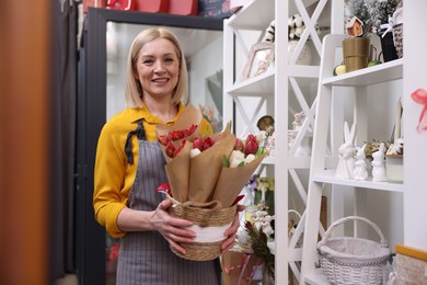 Photo of Business owner with beautiful tulips in her flower shop