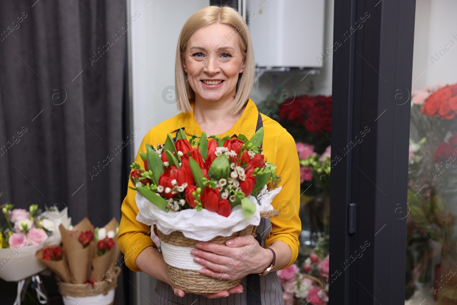 Photo of Business owner with beautiful bouquet in her flower shop