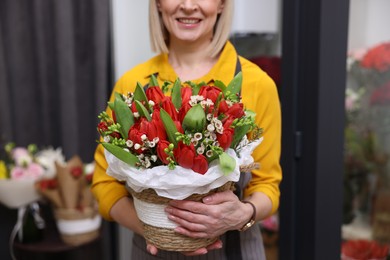 Photo of Business owner with beautiful bouquet in her flower shop, closeup