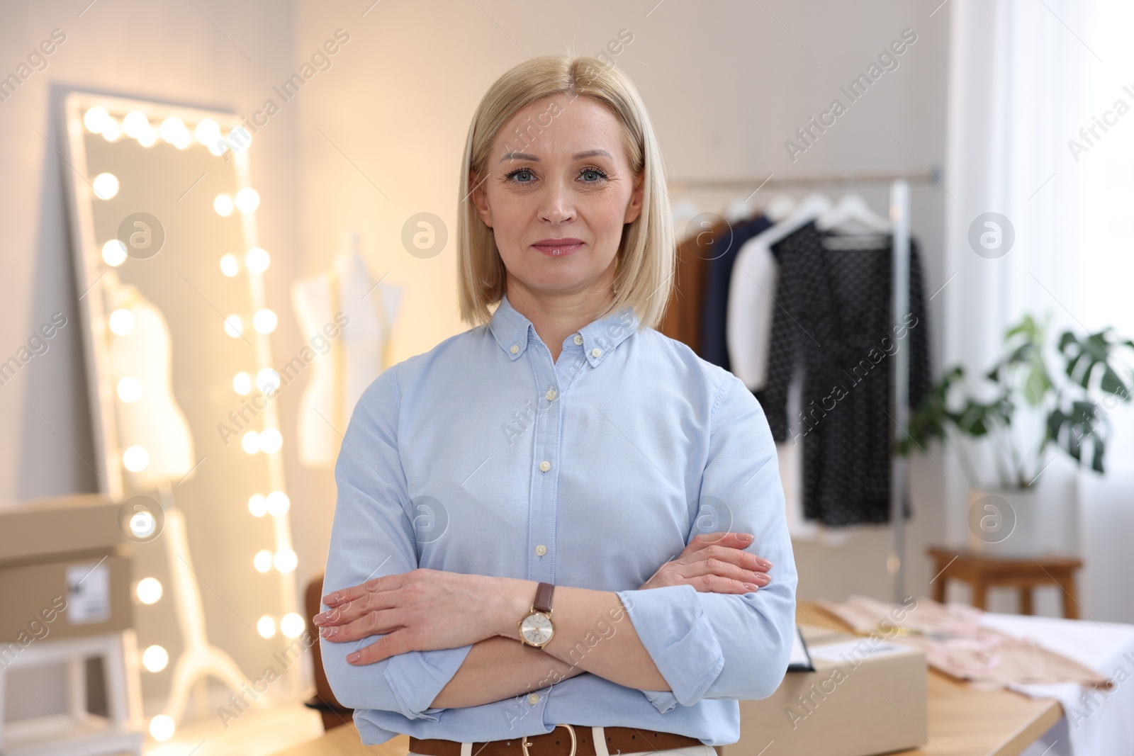 Photo of Business owner with crossed arms in her tailor shop