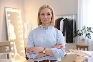 Photo of Business owner with crossed arms in her tailor shop