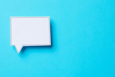 Photo of Blank speech bubble on light blue background, top view. Space for text