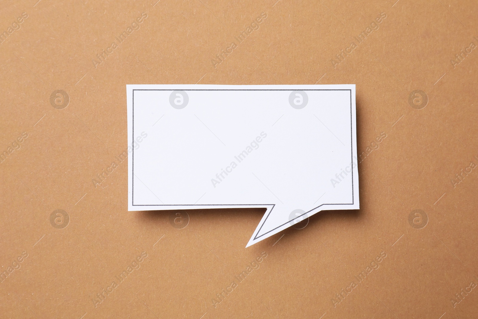 Photo of Blank speech bubble on brown background, top view. Space for text