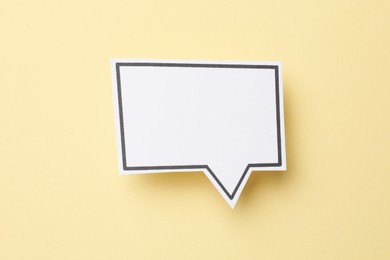 Photo of Blank speech bubble on beige background, top view. Space for text