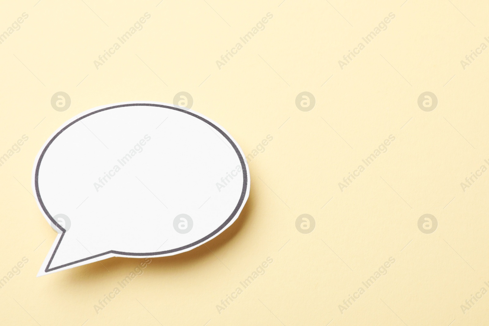 Photo of Blank speech bubble on beige background. Space for text