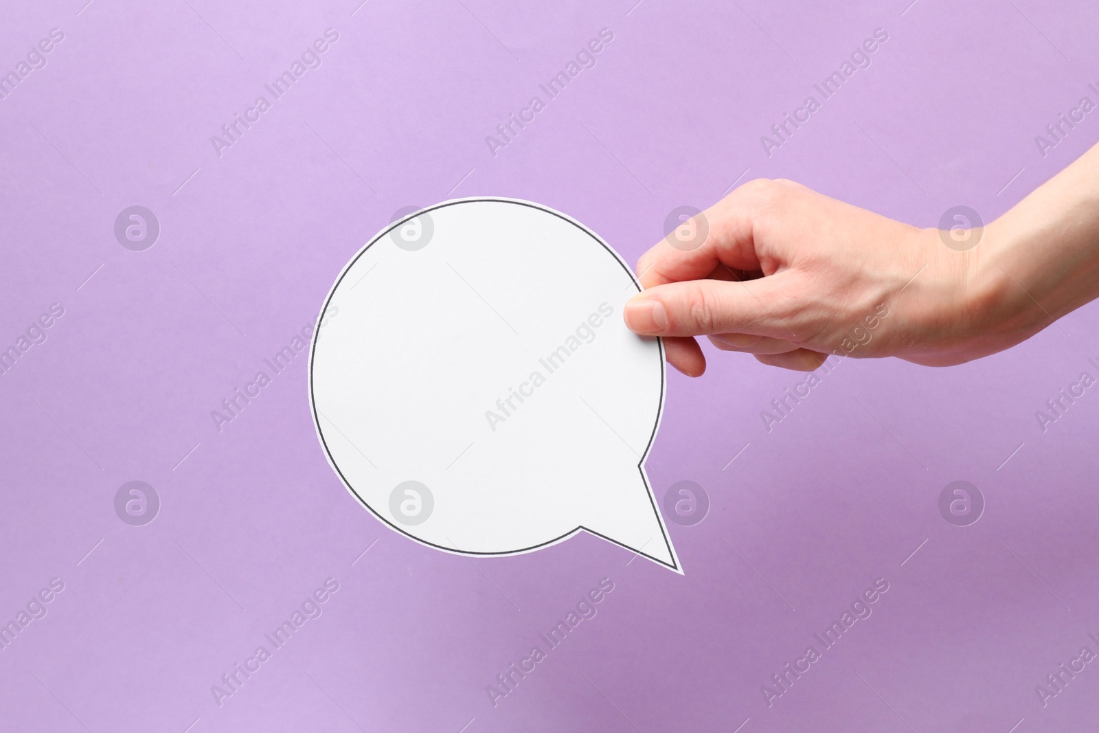 Photo of Woman holding blank speech bubble on lilac background, closeup. Space for text