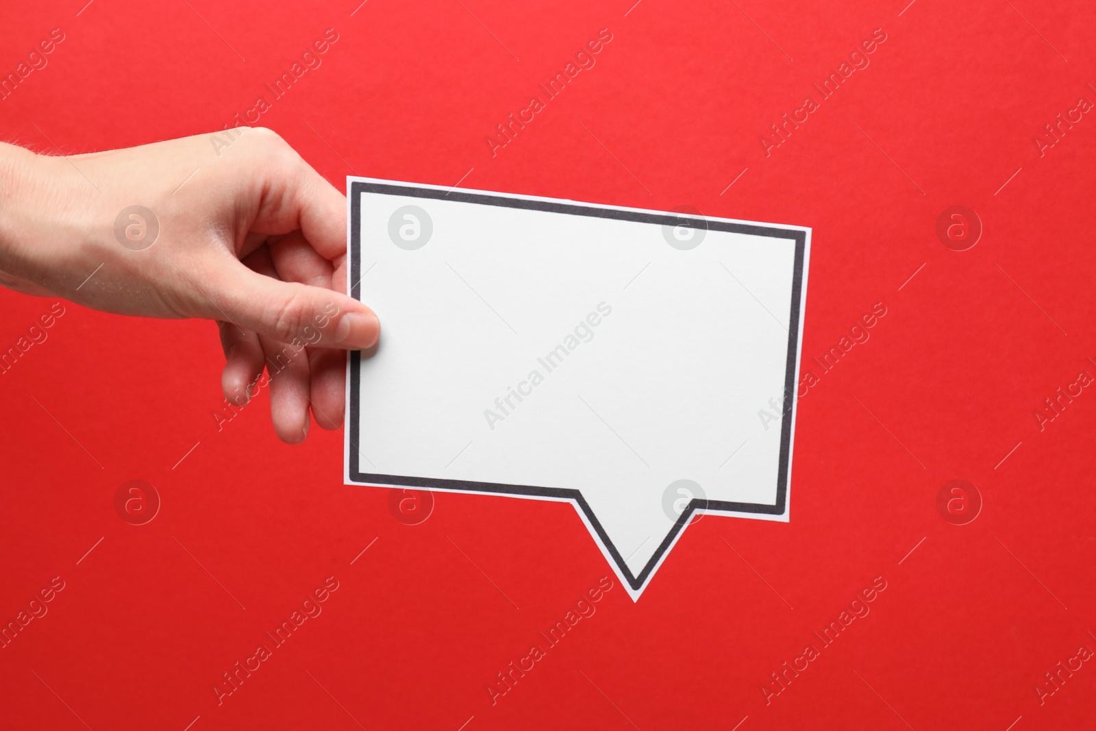 Photo of Woman holding blank speech bubble on red background, closeup. Space for text