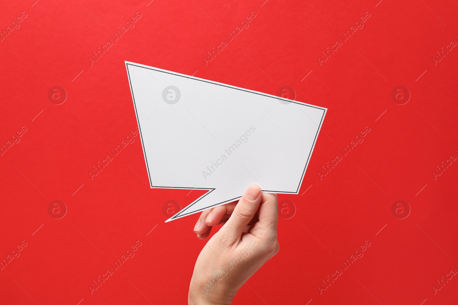 Photo of Woman holding blank speech bubble on red background, closeup. Space for text