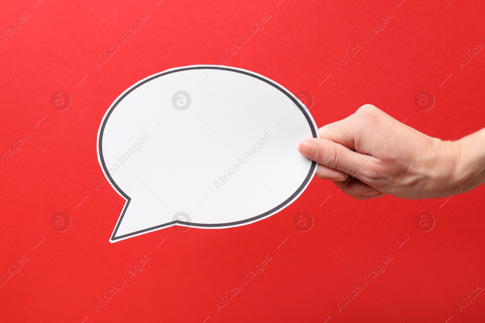 Photo of Woman holding blank speech bubble on red background, closeup. Space for text