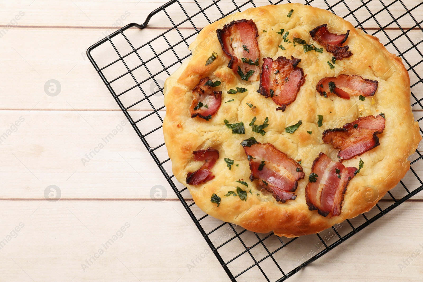 Photo of Delicious focaccia bread with bacon and parsley on white wooden table, top view