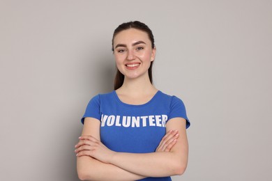 Photo of Portrait of volunteer with crossed arms on grey background