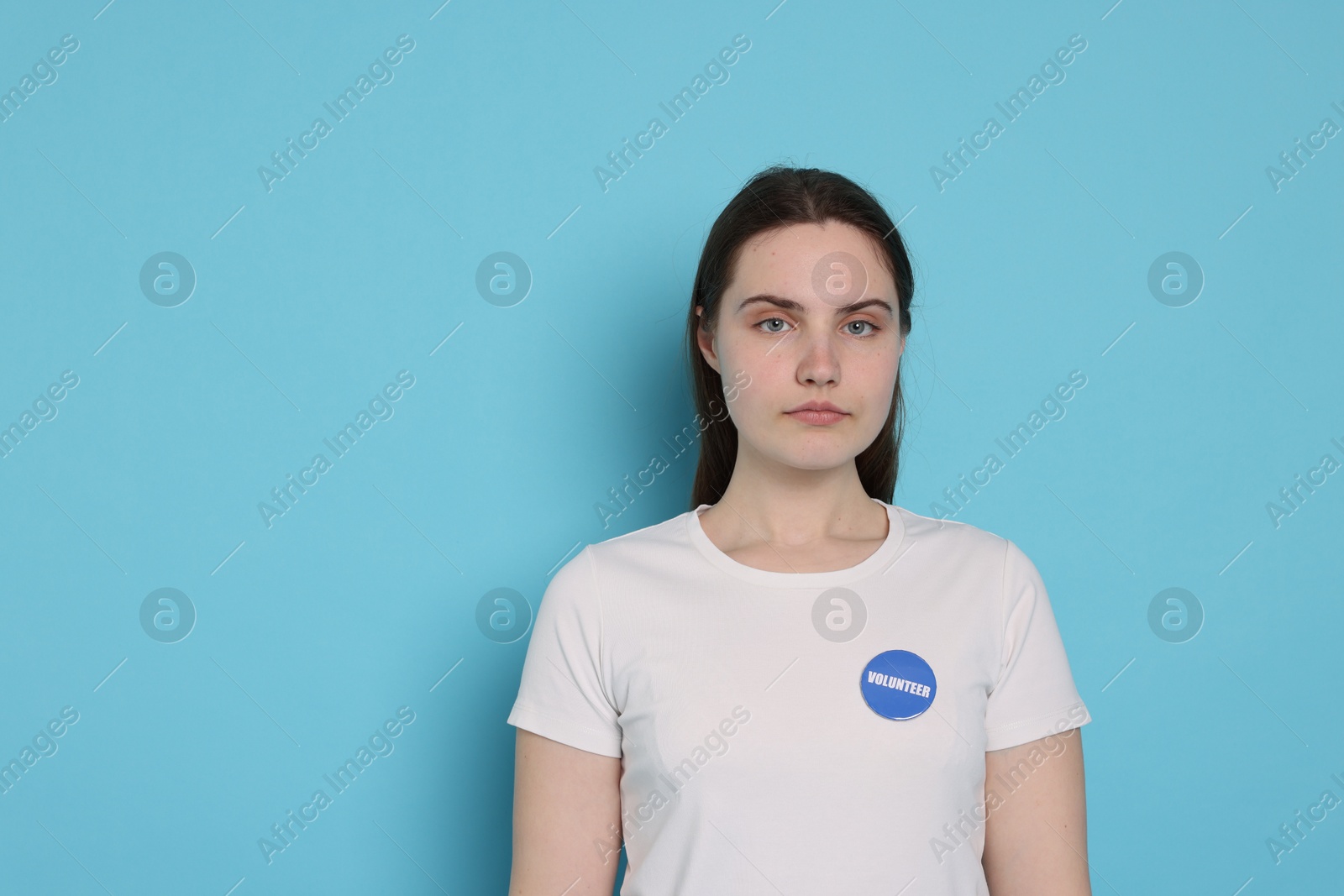 Photo of Portrait of volunteer on light blue background. Space for text