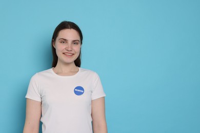 Photo of Portrait of smiling volunteer on light blue background. Space for text