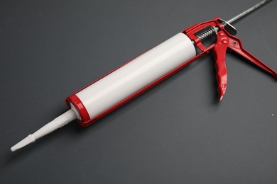 Photo of One glue gun on gray background, above view